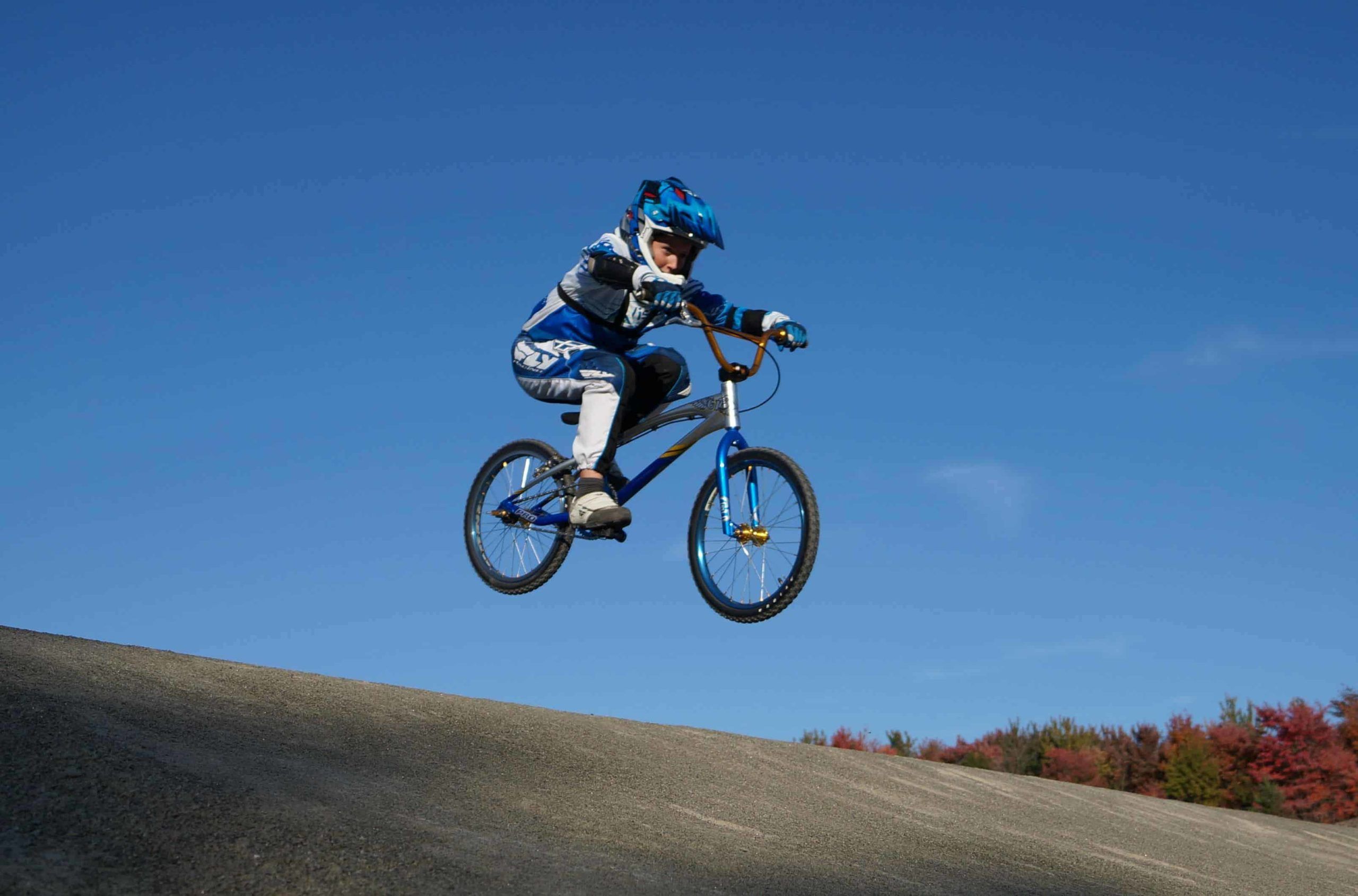 kid on BMX bike in air