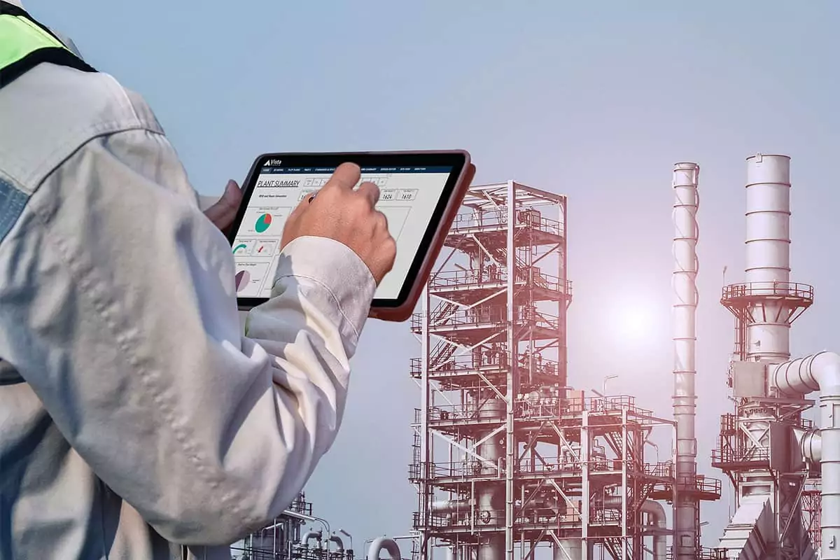 oil plant worker looking at a plant summary dashboard at the facility