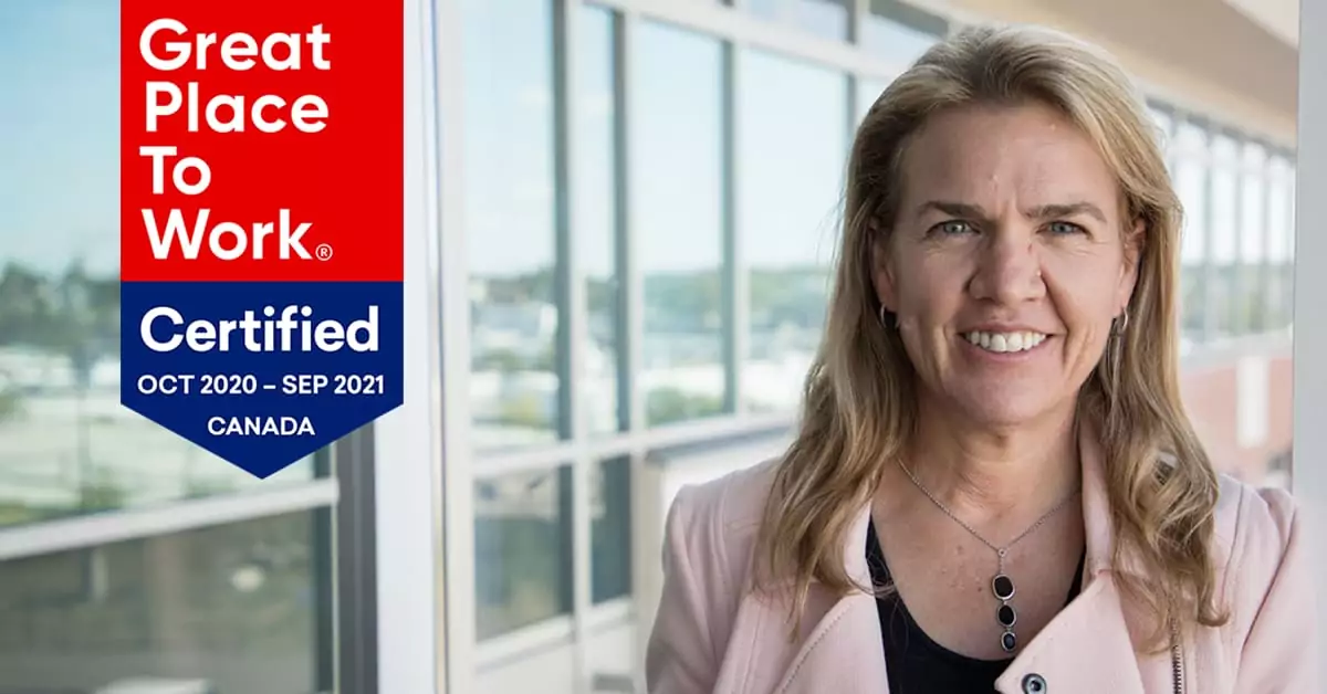 Jennifer Gray at the Vista Projects office with GPTW logo