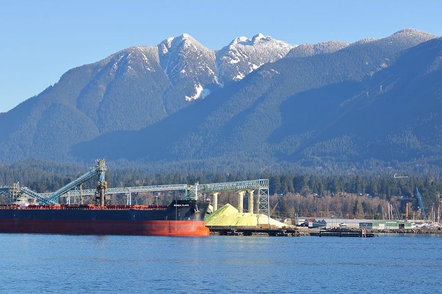 The Songa Flama, a bulk carrier ship registered in the Cayman Islands, loads from the sulfur pile in Vancouver, Canada`s shipping terminal on March 15, 2018.