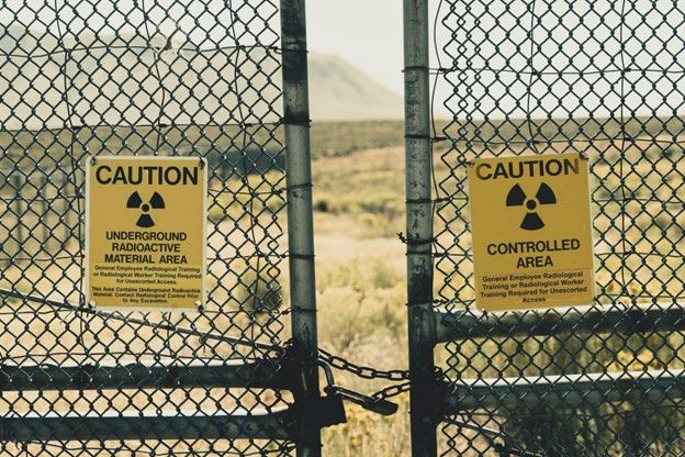 fence and caution signs at a nuclear plant