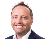 A professional man with short hair and a friendly smile, wearing a dark suit and a white shirt. He appears approachable and confident, suitable for a consultation in the engineering consulting field at Vista Projects.